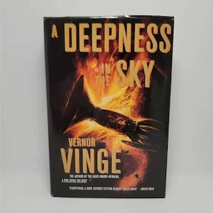 May include: A book cover with a fiery orange and yellow background. The title is "A Deepness in the Sky" by Vernor Vinge. The text "The author of the Hugo Award-winning A Fire Upon the Deep" is also on the cover.