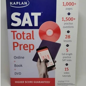 May include: A blue and white book cover with the title "SAT Total Prep" and the Kaplan logo. The cover features a red CD, a hand holding a smartphone, and the text "1,000+ pages", "1,500+ practice questions", "28 lessons", "5 full-length practice SAT tests", "15 video tutorials", and "HIGHER SCORE GUARANTEED".