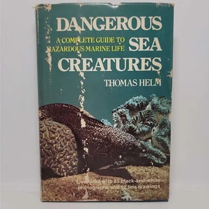 May include: A green book cover with the title "Dangerous Sea Creatures" and the author's name "Thomas Helm". The cover features a black and white illustration of a fish and coral.