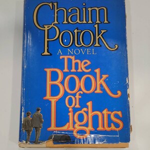 May include: A blue book cover with the title "The Book of Lights" by Chaim Potok. The book is a novel.
