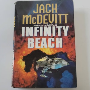 May include: A book cover with a dark blue background and a spaceship flying through a nebula. The title of the book is "INFINITY BEACH" by Jack McDevitt, author of "Moonfall".