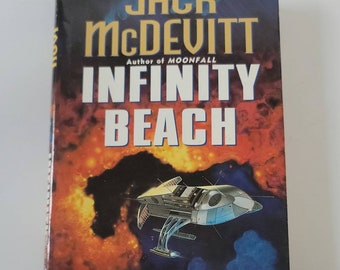 May include: A book cover with a dark blue background and a spaceship flying through a nebula. The title of the book is "INFINITY BEACH" by Jack McDevitt, author of "Moonfall".