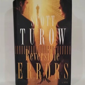 May include: A book cover with a dark background and a couple in the foreground. The title of the book is "Reversible Errors" by Scott Turow. The book is a novel.