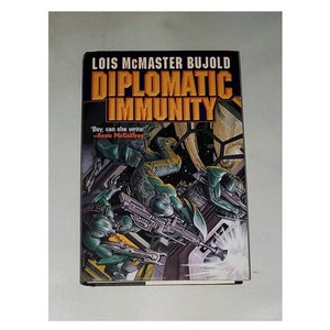 May include: A book cover with a green, yellow, and black illustration of a futuristic scene. The title of the book is "Diplomatic Immunity" by Lois McMaster Bujold. The quote "Boy, can she write!" by Anne McCaffrey is printed below the title.