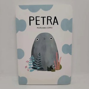 May include: A book cover with a light blue background and white polka dots. The title "PETRA" is in black text and the author "MARIANNA COPPO" is in smaller black text. A gray, cartoon-like creature with a happy face is in the center of the cover. The creature is surrounded by green and blue plants.