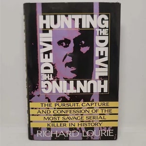 May include: A book cover with a black and white image of a man's face. The title of the book is "Hunting the Devil" and the subtitle is "The Pursuit, Capture and Confession of the Most Savage Serial Killer in History". The author is Richard Lourie.