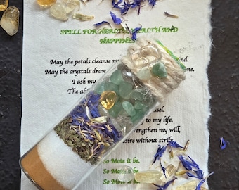 May include: A glass bottle filled with dried flowers, herbs, and crystals. The bottle is tied with twine and has a label that reads "SPELL FOR HEALTH, WEALTH AND HAPPINESS". May the petals cleanse me. May the crystals draw. I ask my. The ab. nd. me. ssel. to my life. rengthen my will, sire without strife. So Mote it be. So Mote it be. So Mote it be.