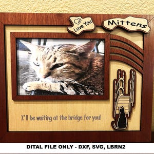 May include: Wooden picture frame with a photo of a cat. The frame has a dark brown border and a light brown interior. Decorative elements include the words "Love You" and "Mittens", and a silhouette of a cat. Text: "I'll be waiting at the bridge for you!"