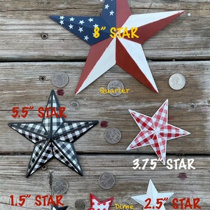 May include: Size comparison of five different sized metal stars with a US flag star measuring 8 inches, a black and white checkered star measuring 5.5 inches, a red and white checkered star measuring 3.75 inches, a white star measuring 2.5 inches, and a red and white polka dot star measuring 2.25 inches. A quarter and a dime are included for size reference.