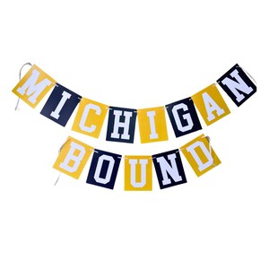 May include: A yellow and black banner with the text "Michigan Bound" in white letters.