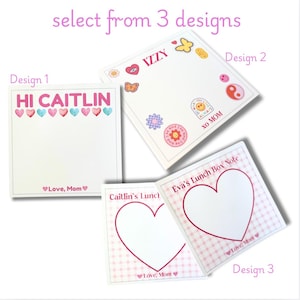 May include: Three different designs for a lunchbox note. Design 1 is a white card with pink hearts and the text "HI CAITLIN" and "Love, Mom". Design 2 is a white card with a pink heart, a butterfly, an eye, and the text "IZZY". Design 3 is a pink and white checkered card with a large pink heart and the text "Eva's Lunch Box Note" and "Love, Mom".