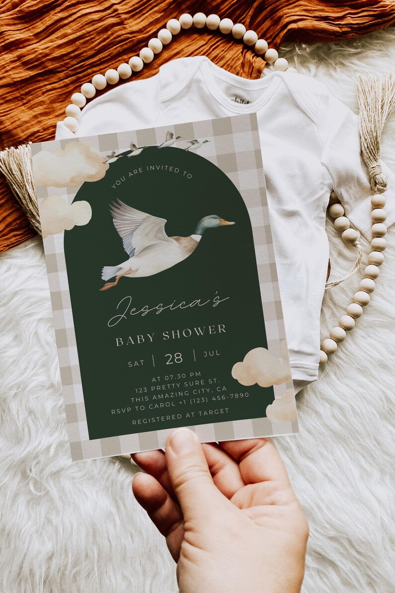 May include: A baby shower invitation with a green and white gingham pattern. The invitation features a watercolor illustration of a duck flying in front of a green circle. The text on the invitation reads "You are invited to Jessica's Baby Shower Sat 28 Jul at 07.30 PM 123 Pretty Sure St. This Amazing City, CA RSVP to Carol (123) 456-7890 Registered at Target"