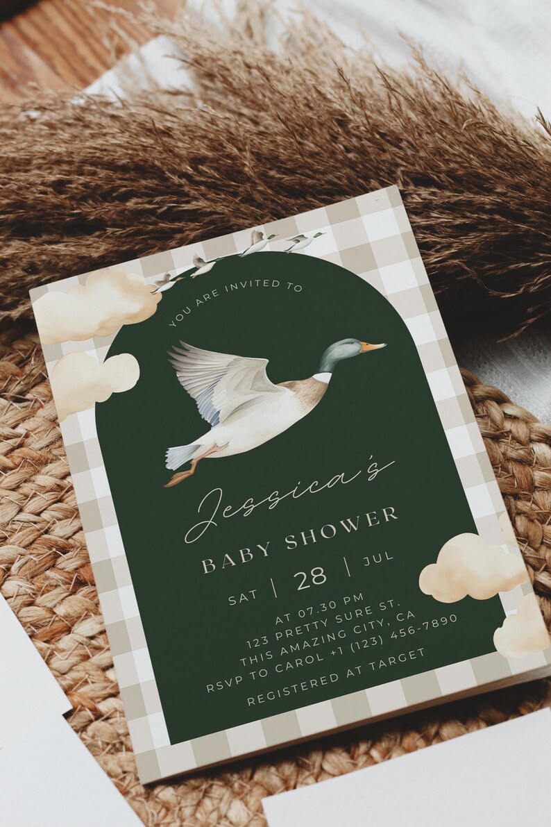 May include: A green and white gingham baby shower invitation with a watercolor illustration of a duck flying through the air. The text reads "You are invited to Jessica's Baby Shower Sat | 28 | Jul AT 07.30 PM 123 Pretty Sure St. This Amazing City, CA RSVP to Carol +1 (123) 456-7890 Registered at Target"