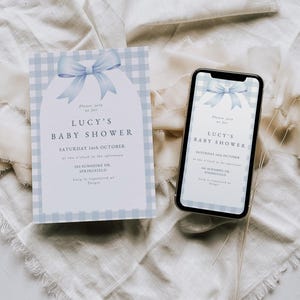 May include: A blue and white gingham baby shower invitation with a blue bow. The invitation reads "Please join us for Lucy's Baby Shower, Saturday 16th October at two o'clock in the afternoon, 202 Sunshine Dr., Springfield. Lucy is registered at Target."