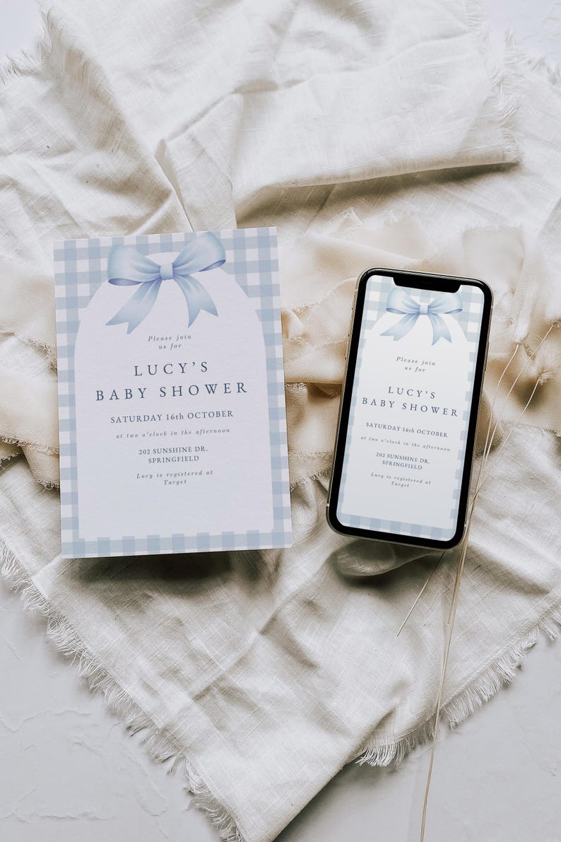 May include: A blue and white gingham baby shower invitation with a blue bow. The invitation reads "Please join us for Lucy's Baby Shower, Saturday 16th October at two o'clock in the afternoon, 202 Sunshine Dr., Springfield. Lucy is registered at Target."