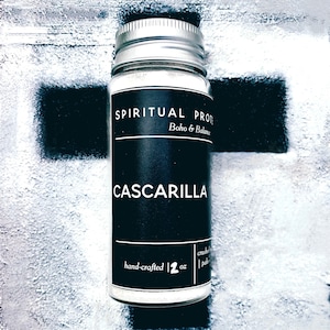 May include: A small white jar with a black label that reads "SPIRITUAL PROTECTION Boho & Balance CASCARILLA hand-crafted 2 oz crushed palo santo"
