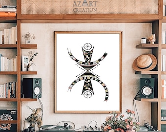 May include: A black and white geometric art print with colorful accents, featuring a stylized human figure. The print is framed and hanging on a wall in a modern living room with a wooden table and shelves filled with books.