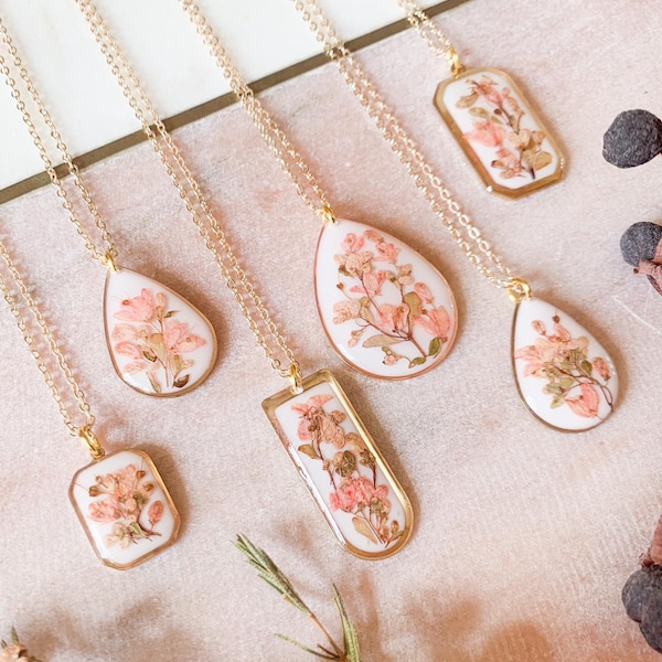 Pressed flower resin necklace on a gold plated chain.