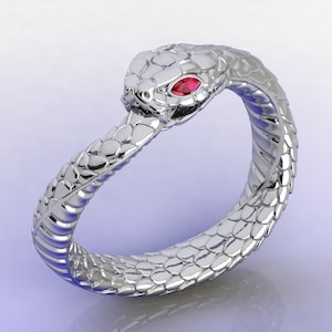 May include: A silver snake ring with a red gemstone eye. The snake is coiled around the ring band.