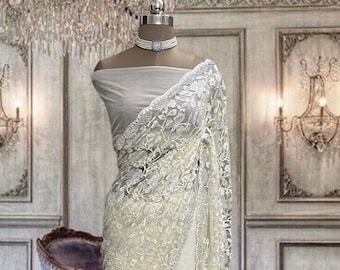 Pearl white net saree with thread and stone work and running blouse piece