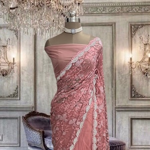 Peach net saree with thread and stone work and running blouse piece