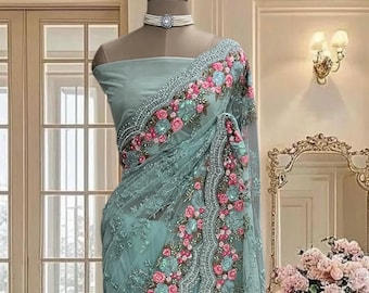 Aqua Blue net saree with multi colored thread work and stone embroidery, includes a running blouse piece, party wear saree