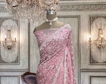 Pastel pink net saree with thread and stone work and running blouse piece