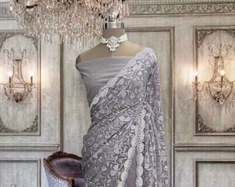 Dusty purple net saree with thread and stone work and running blouse piece