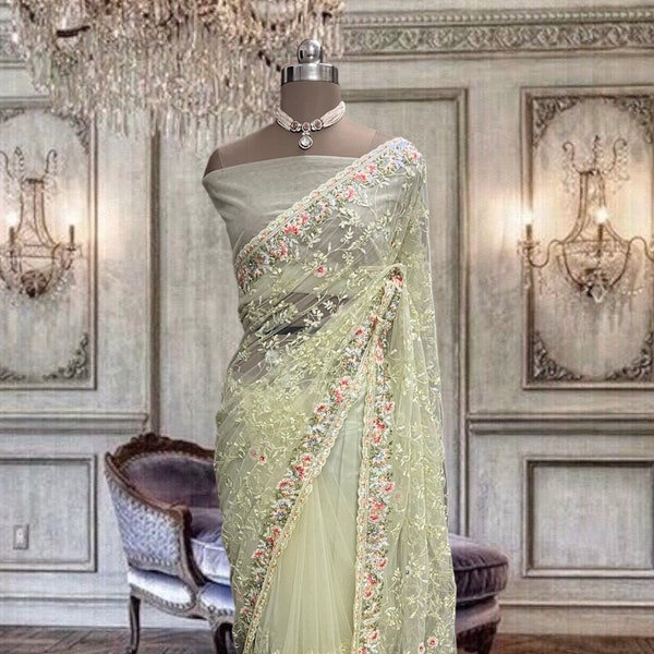 Beautiful lime yellow-green net saree with thread and sequins work and running blouse piece