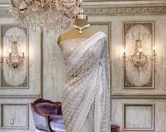 Light lavender net saree with sequins work and running blouse piece