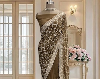 Beige gold net saree with zari and sequins work, includes a running blouse piece.
