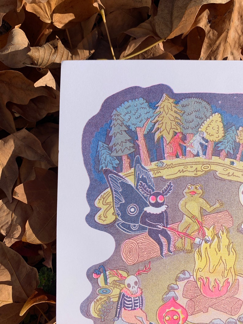 May include: A whimsical illustration of a campfire scene with a skeleton, a frog, and a moth with large, black wings. The scene is set in a forest at night with a starry sky. The characters are gathered around a campfire, roasting marshmallows.