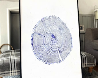 May include: A framed print of a blue and white tree ring design. The print is in a black frame and is hanging on a wall.