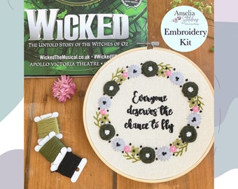 May include: Embroidery kit featuring a hoop with a green floral wreath and the quote "Everyone deserves the chance to fly". The kit includes green and black embroidery floss.