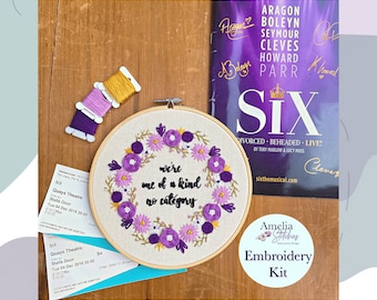 May include: An embroidery kit with a floral design and the text "we're one of a kind no category." The kit includes embroidery floss in yellow, purple, and lavender, along with a playbill and two theater tickets. The kit is from Amelia Stitches.