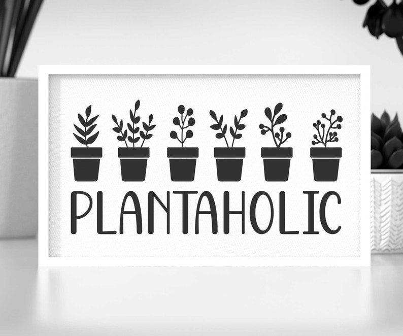 May include: Black and white sign with the text "Plantaholic" and a row of seven potted plants with different leaf shapes.