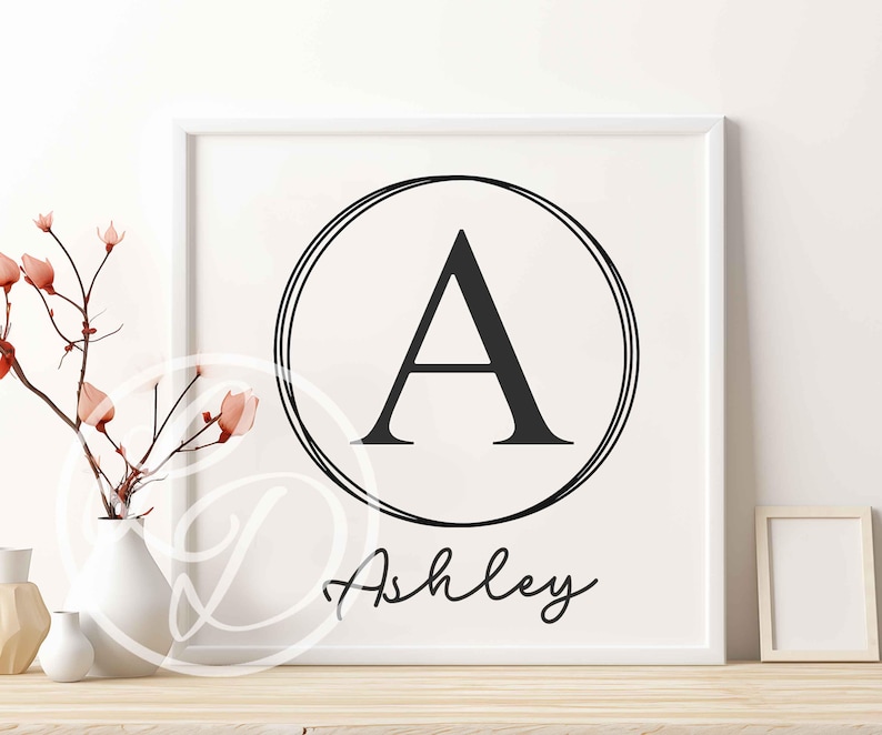 May include: A black and white printable wall art design featuring a large letter A in a circle with the name Ashley written below.