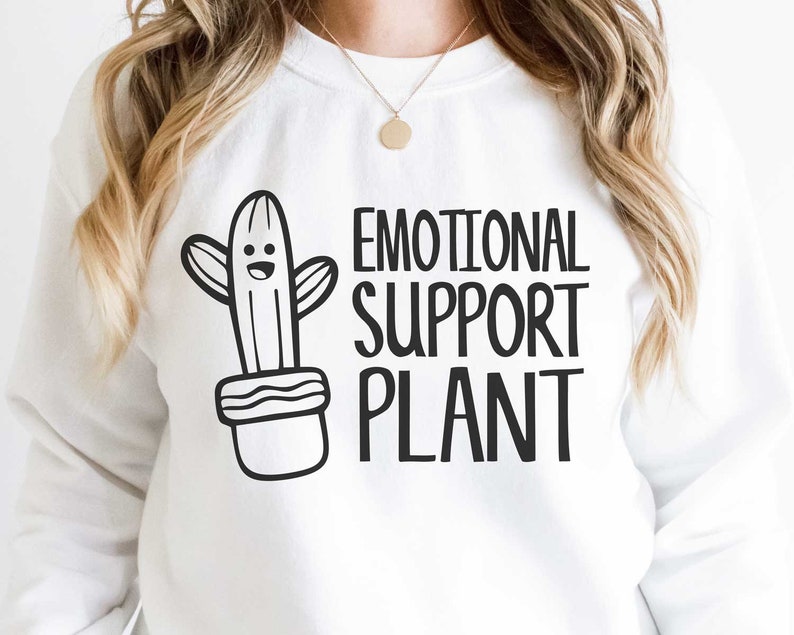 May include: White sweatshirt with a black and white illustration of a cactus in a pot and the text "Emotional Support Plant".