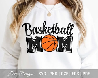 May include: White sweatshirt with black text that reads "Basketball Mom" and a black and orange basketball graphic.