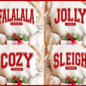 May include: Four cream-colored sweatshirts with red text. The sweatshirts have the words "FALALALA", "JOLLY VIBES", "COZY SEASON", and "SLEIGH QUEEN" printed on them. Each sweatshirt is paired with a wrapped gift and holiday greenery.