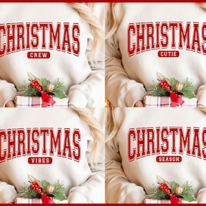 May include: Cream-colored sweatshirts with the word "CHRISTMAS" in red block letters. Each sweatshirt has a different secondary word: "CREW", "CUTIE", "VIBES", and "SEASON". A wrapped gift with a red bow and greenery is held in front.