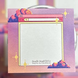 May include: Square notepad with a pixelated internet browser design in pink, purple, and yellow. The notepad features a search bar and the text "Angelic Angel Gifts Shop for the Cute & Brave".