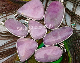 May include: A collection of eight purple gemstone pendants with silver settings. The pendants are various shapes, including oval, teardrop, and triangular.