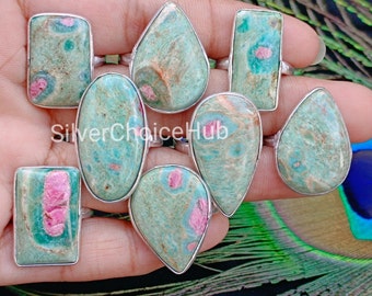 May include: Nine silver rings with green and pink gemstone settings. The gemstones are a mix of oval, teardrop, and rectangular shapes.