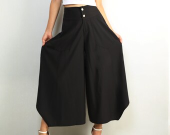 May include: Black wide-leg pants with a high waist and a button closure. The pants have a slightly flared shape and are made of a lightweight fabric.