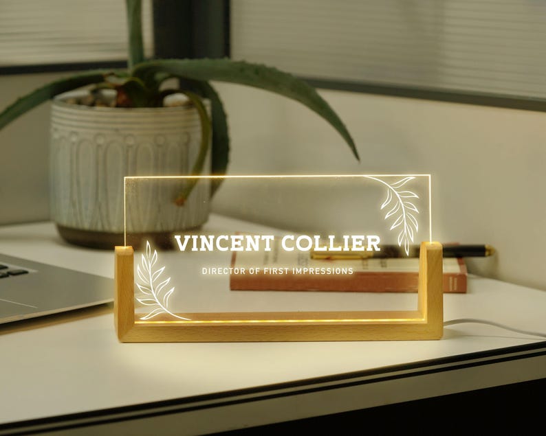 a glass plaque sitting on top of a desk next to a laptop