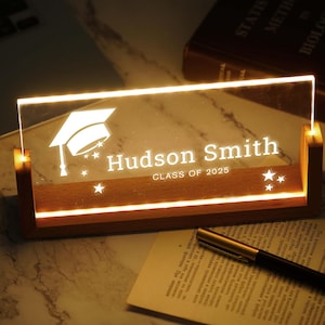 a glass plaque with a graduation cap on it