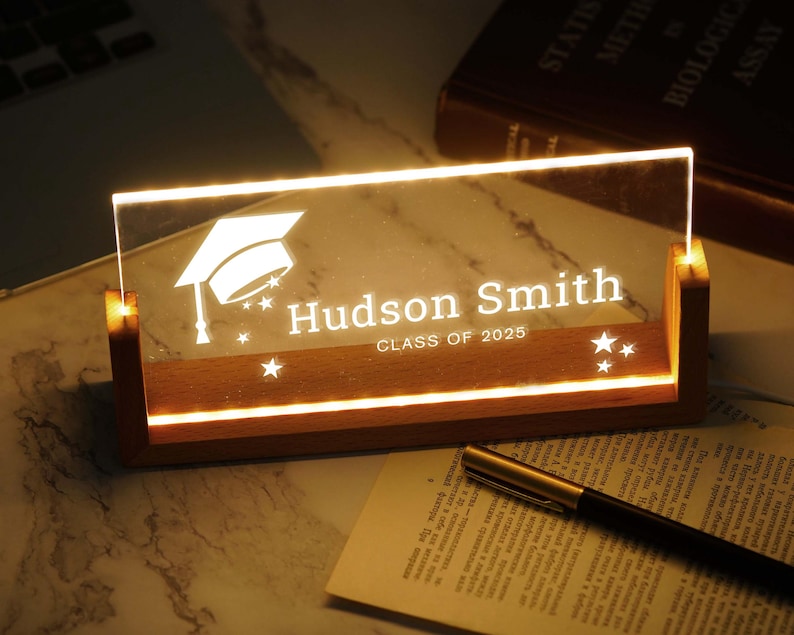 a glass plaque with a graduation cap on it