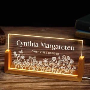 a lighted sign with a picture of flowers on it