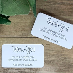 May include: Two white thank you cards with black text. The top card says "Thank you" with a small heart and "For your purchase and supporting my small business" followed by "CntryGraceCreations". The bottom card says "Thank you" with a small heart and "For your purchase and supporting my small business" followed by "Your business name".